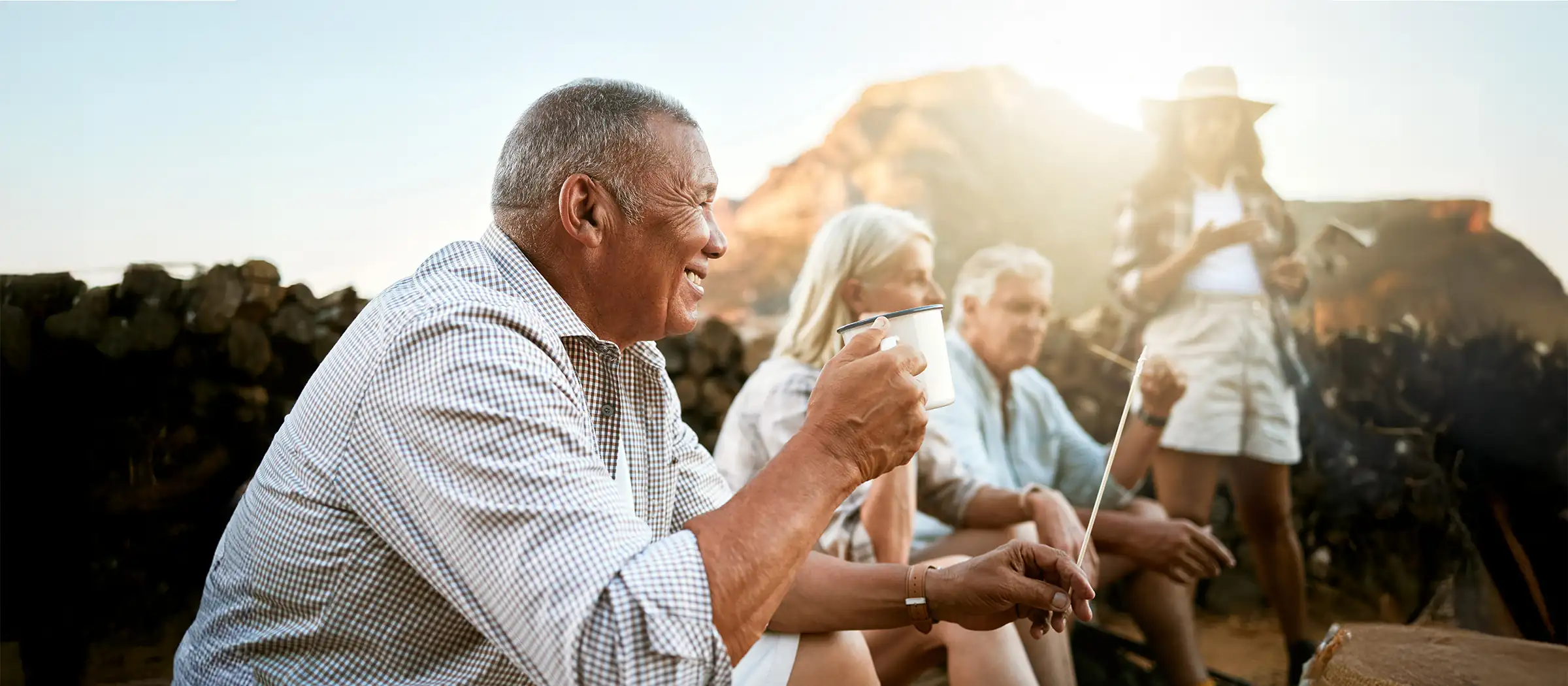 group of joyful older friends camping